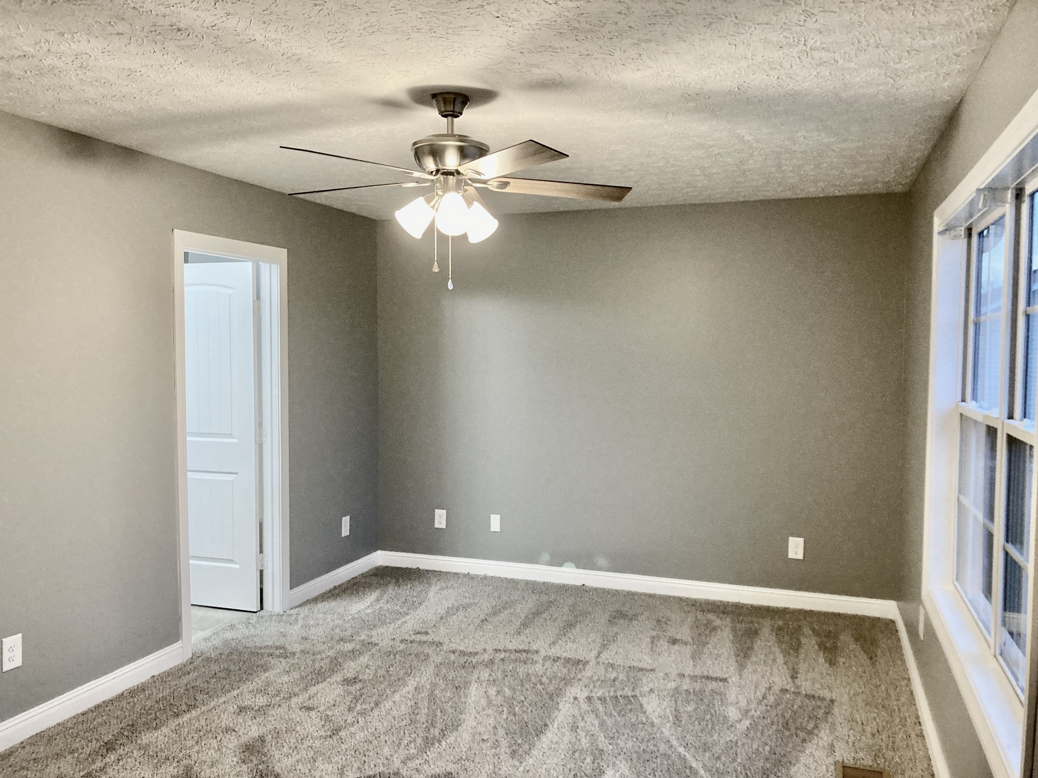 128 T G T Road Portland, TN 37148 - Photo 6 of 8 an empty room with windows and fan