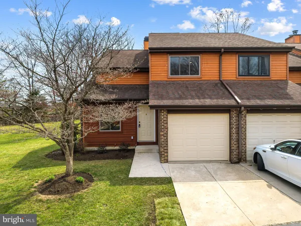 a front view of a house with a yard garage and outdoor seating