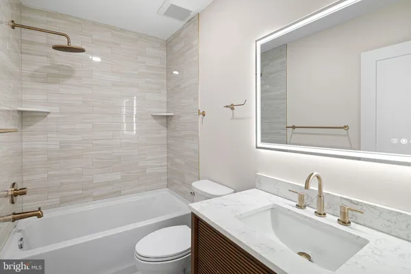 an empty room with wooden floor and a ceiling fan