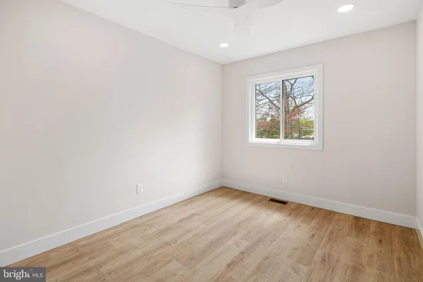 a bathroom with a granite countertop sink a toilet and a mirror