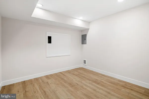 a view of a big building with a big yard and large trees