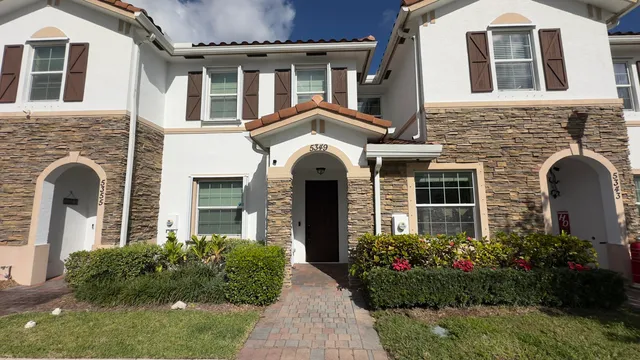 a front view of a house with a garden