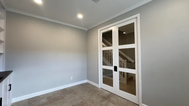 an empty room with wooden floor and a window