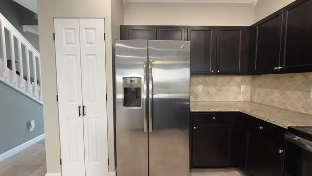 a kitchen with a refrigerator and cabinets