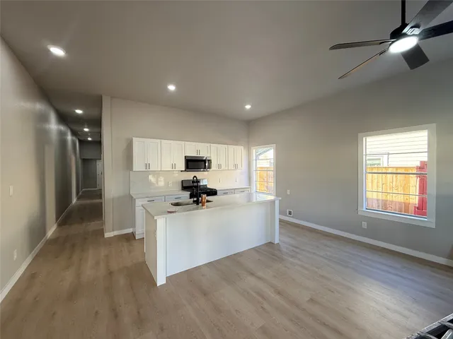 a kitchen with stainless steel appliances a refrigerator sink and stove