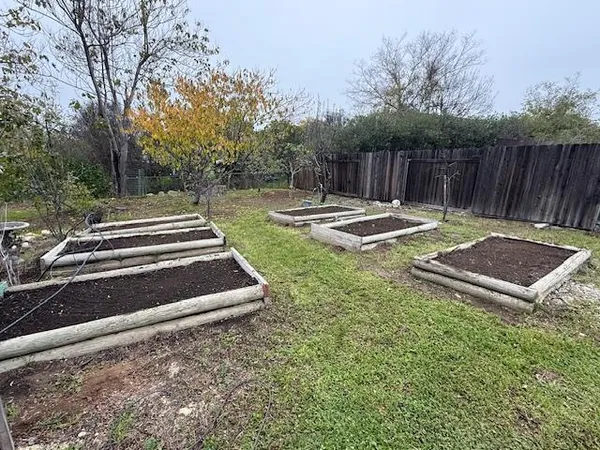 a backyard of a house with table and chairs