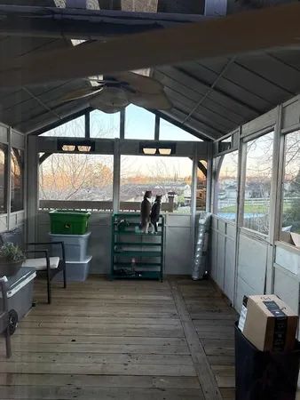 a view of a porch with furniture and a yard