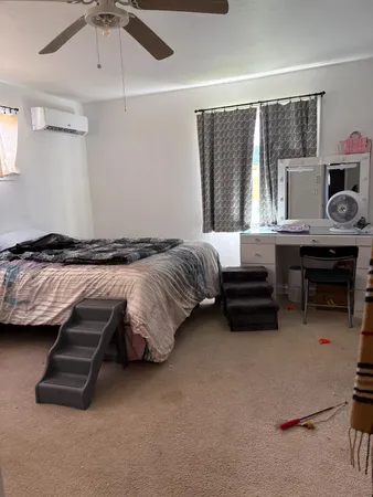 a bedroom with bed and a window