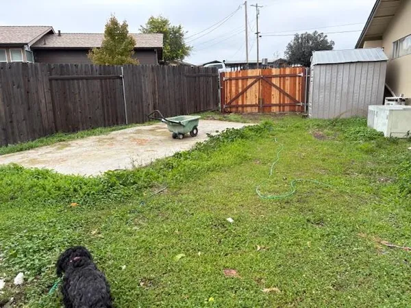 a backyard of a house with table and chairs