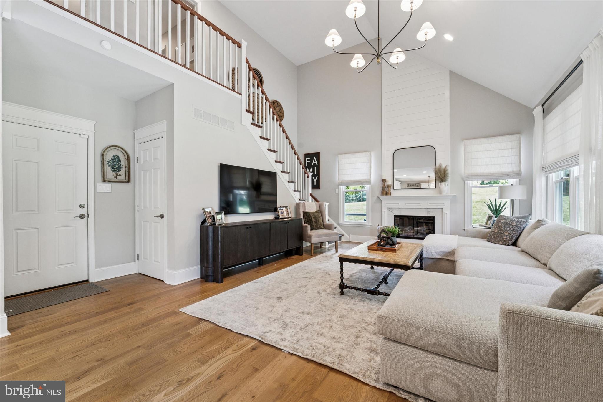 5 Stoney End Road Broomall, PA 19008 - Photo 21 of 48 a living room with furniture a fireplace and a flat screen tv
