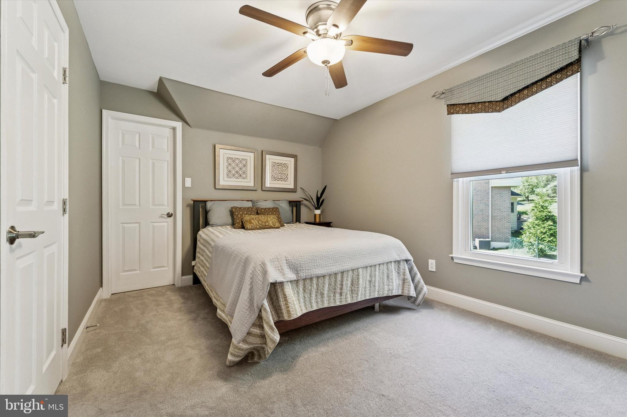 5 Stoney End Road Broomall, PA 19008 - Photo 28 of 48 a bedroom with a large bed and a chandelier fan