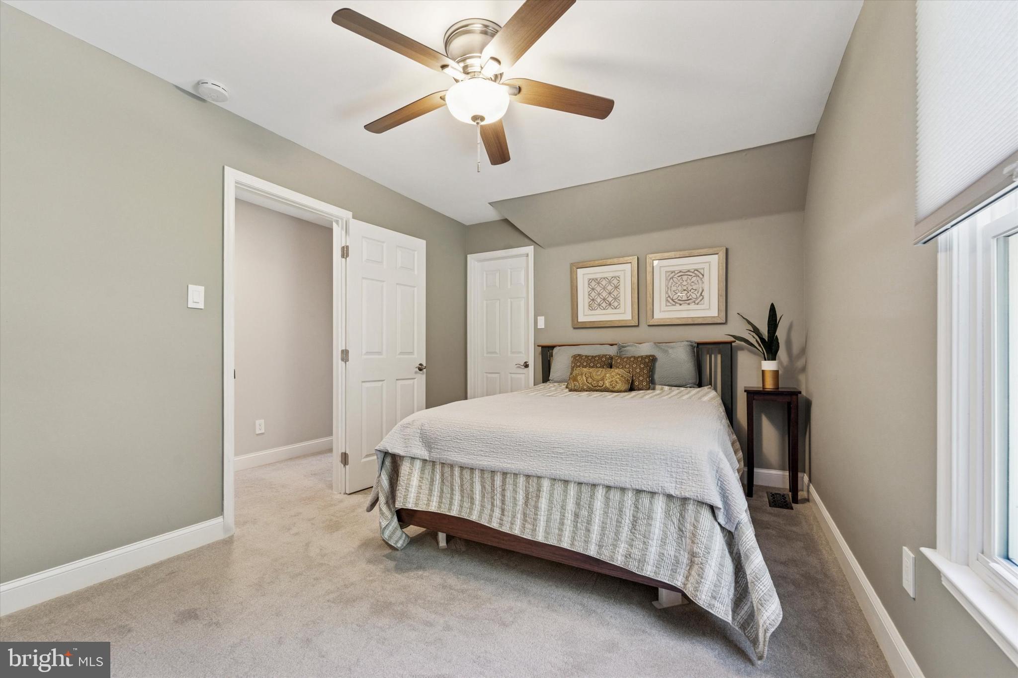 5 Stoney End Road Broomall, PA 19008 - Photo 29 of 48 a bedroom with a bed and a chandelier