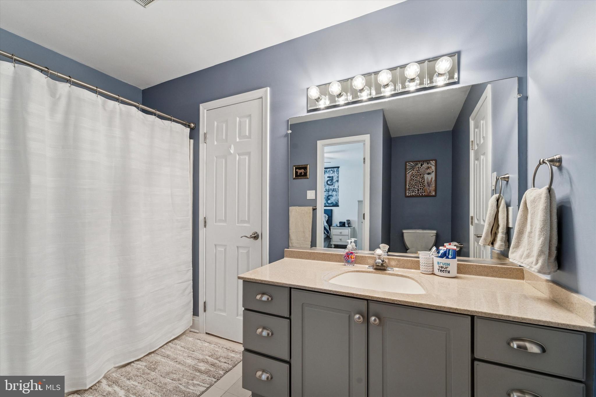 5 Stoney End Road Broomall, PA 19008 - Photo 35 of 48 a bathroom with a double vanity sink and a mirror