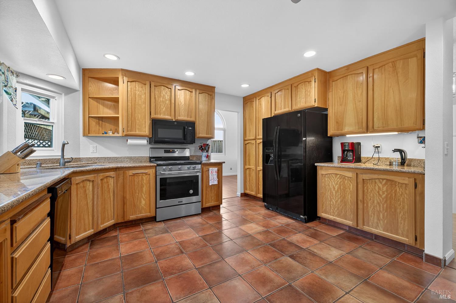 5410 Corbett Circle Santa Rosa, CA 95403 - Photo 3 of 41 a kitchen with a refrigerator a stove top oven a sink and dishwasher