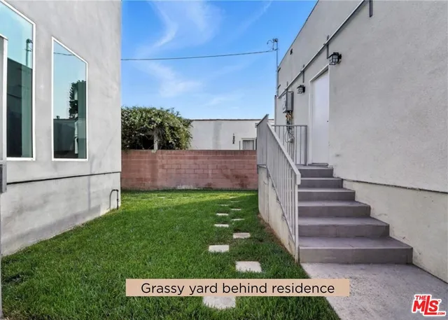 a view of house with backyard