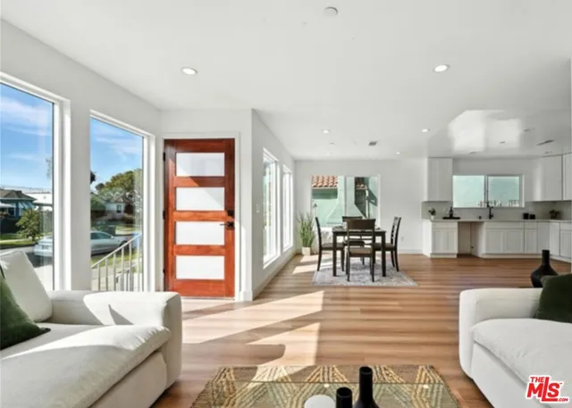 a living room with furniture and large windows