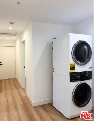 a view of a hallway with washer and dryer