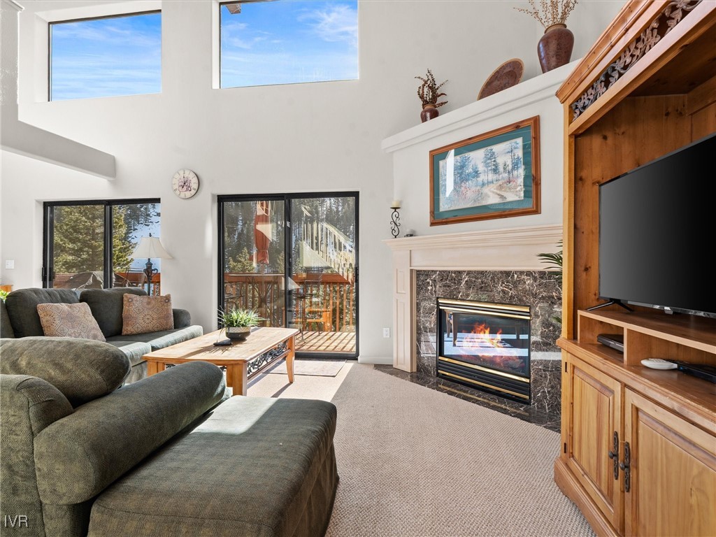 400 Fairview Boulevard, Unit 173 Incline Village, NV 89451 - Photo 8 of 34 a living room with furniture a flat screen tv and a fireplace