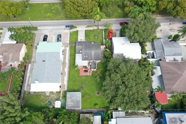 an aerial view of residential houses with outdoor space and street view