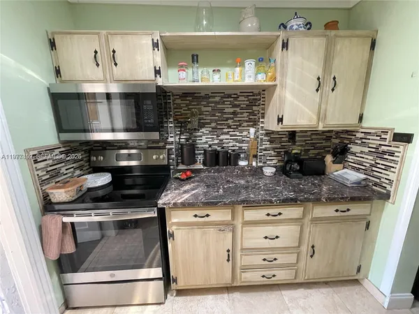 a kitchen with granite countertop a stove and a sink