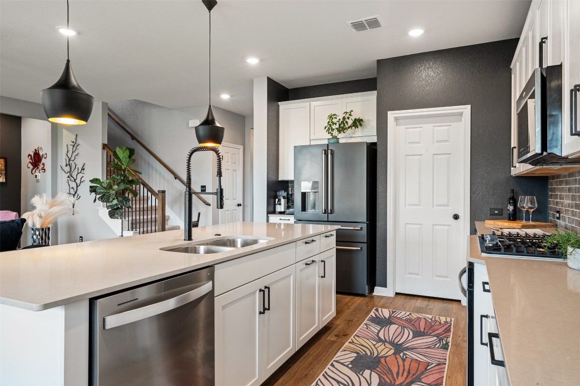1009 Dog Iron Street Georgetown, TX 78633 - Photo 17 of 39 a kitchen with a sink stainless steel appliances and cabinets