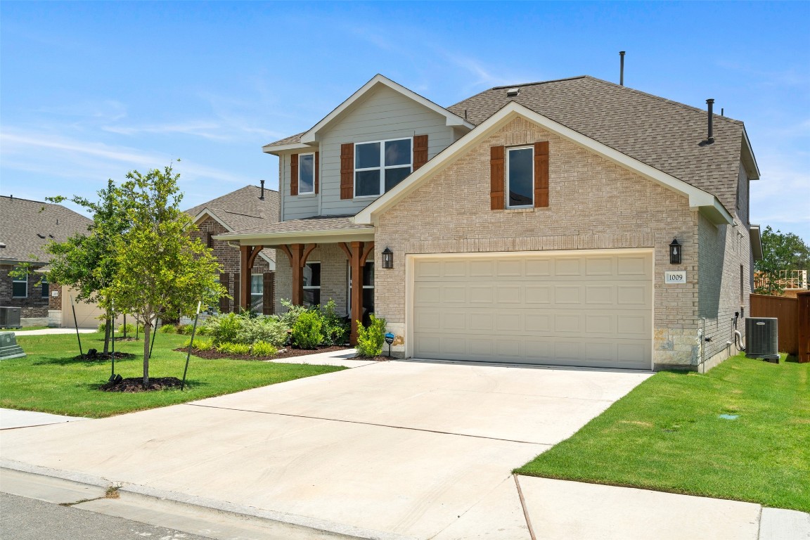 1009 Dog Iron Street Georgetown, TX 78633 - Photo 2 of 39 a front view of house with yard