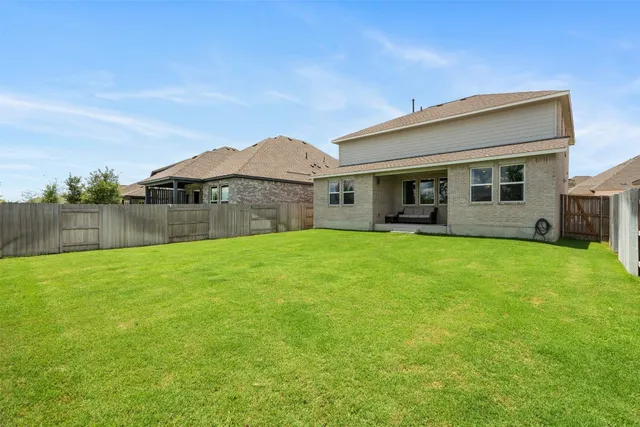 a view of a backyard with a garden and entertaining space