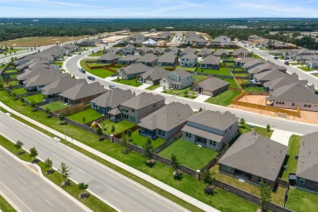 an aerial view of a house with a yard