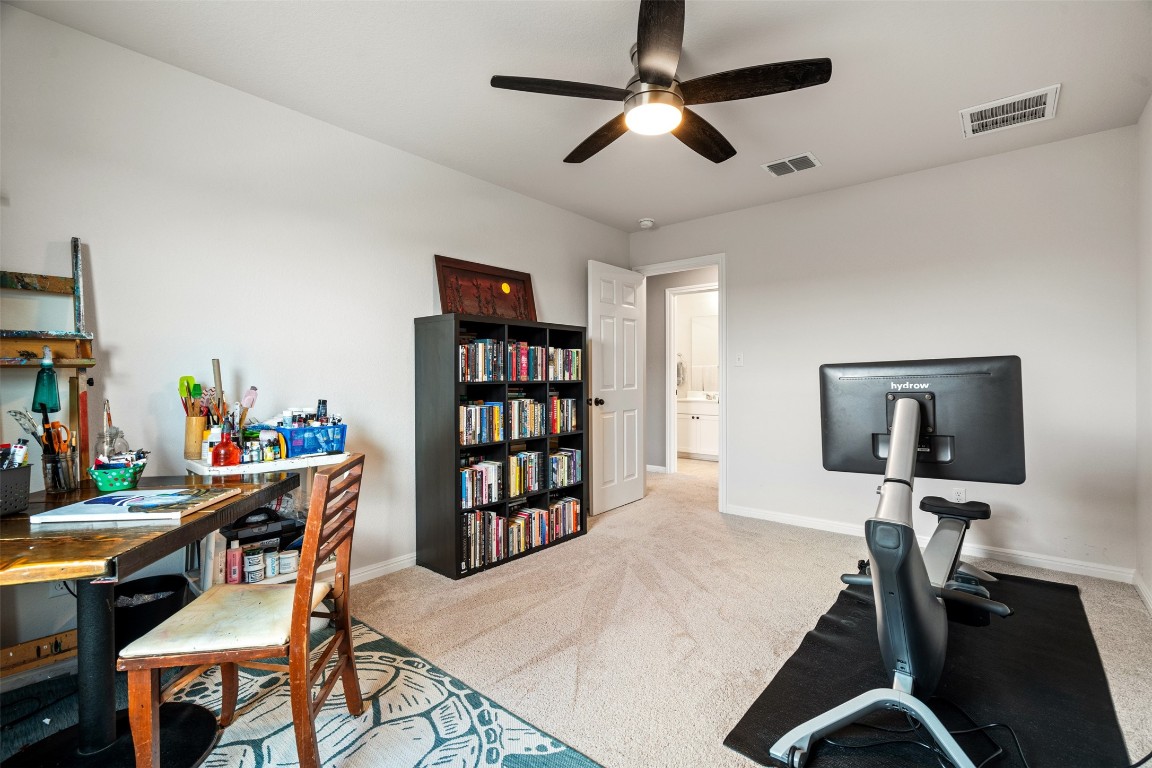 1009 Dog Iron Street Georgetown, TX 78633 - Photo 29 of 39 a workspace with furniture wooden floor and a window