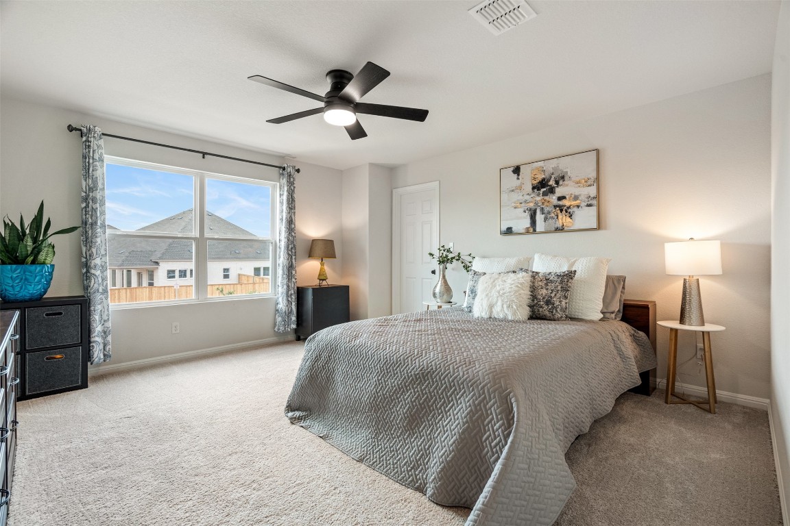 1009 Dog Iron Street Georgetown, TX 78633 - Photo 30 of 39 a spacious bedroom with a bed and a large window