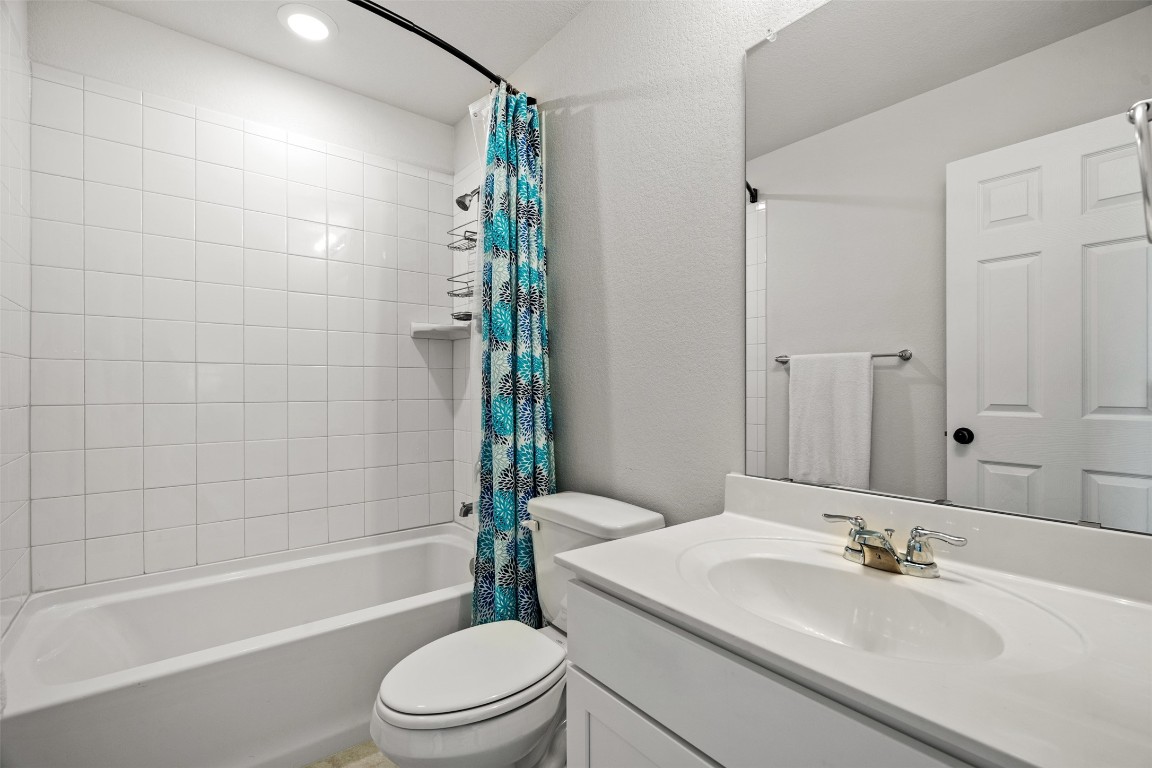 1009 Dog Iron Street Georgetown, TX 78633 - Photo 32 of 39 a bathroom with a sink a toilet and shower