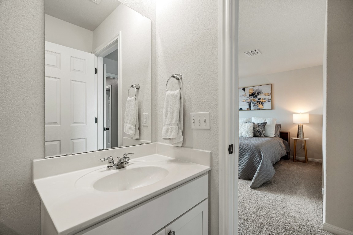 1009 Dog Iron Street Georgetown, TX 78633 - Photo 33 of 39 a en suite bathroom with a sink and a mirror