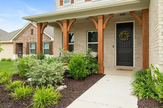 a front view of a house with garden