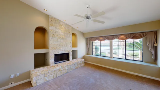 a living room with a fireplace furniture and a large window