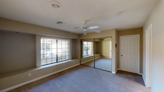 a bathroom with a tub shower sink and mirror