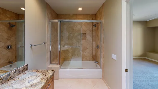 an empty room with closet and a chandelier fan