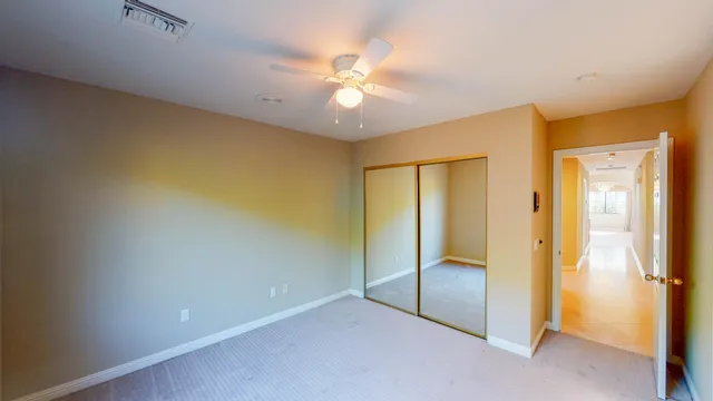 a bathroom with a granite countertop sink a mirror and a shower