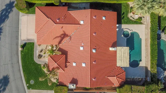 an outdoor view of a house with swimming pool