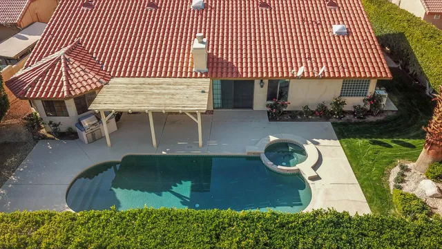a view of a house with backyard and sitting area