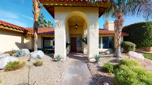 a view of a house with backyard and sitting area