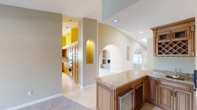 an empty room with fireplace and windows