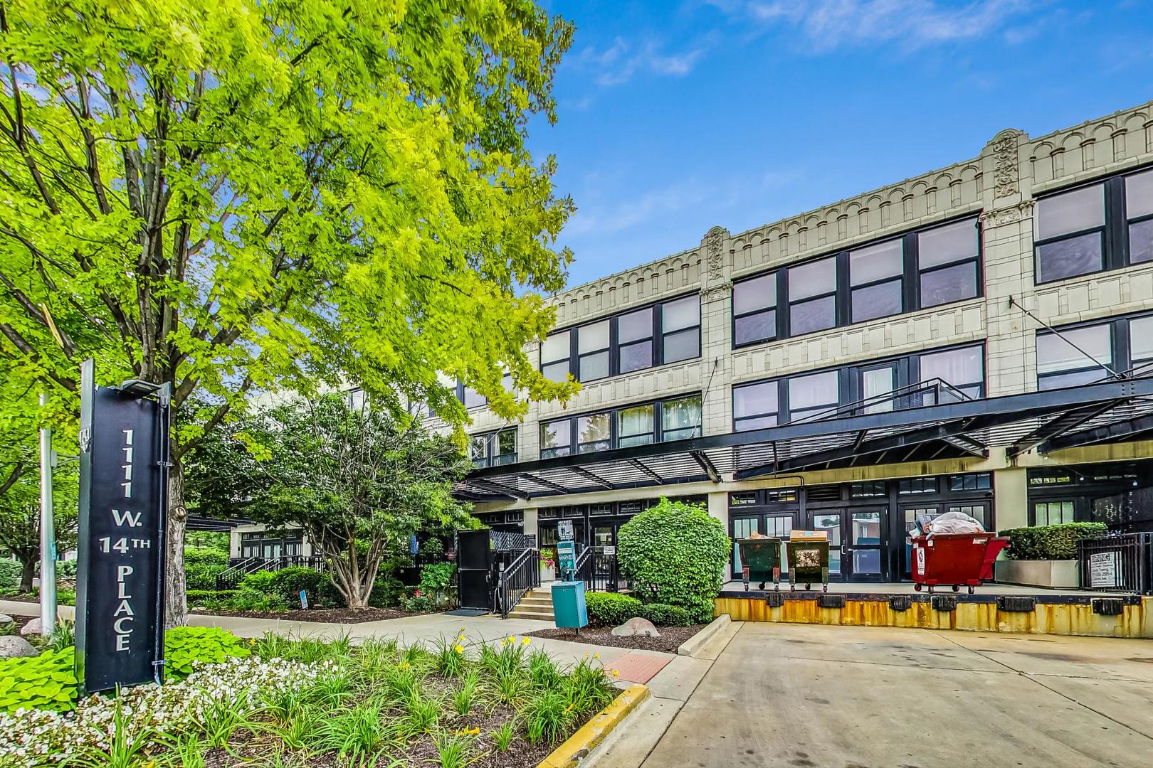 1111 West 14th Place, Unit 110 Chicago, IL 60608 - Photo 1 of 24 a view of a building with a garden