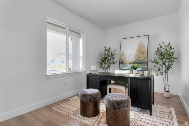 342 North Rhyolite Drive, Unit 88 Hurricane, UT 84737 - Photo 3 of 26 Bright interior room featuring a large window, light-toned walls, and wood-finish flooring