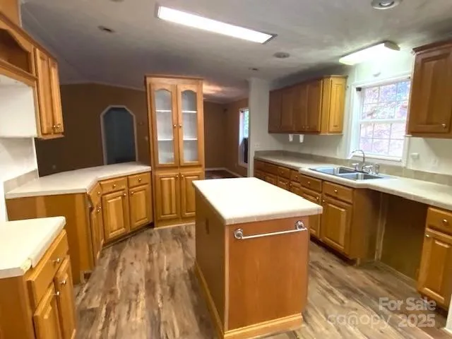 a kitchen that has a sink and a wooden floor