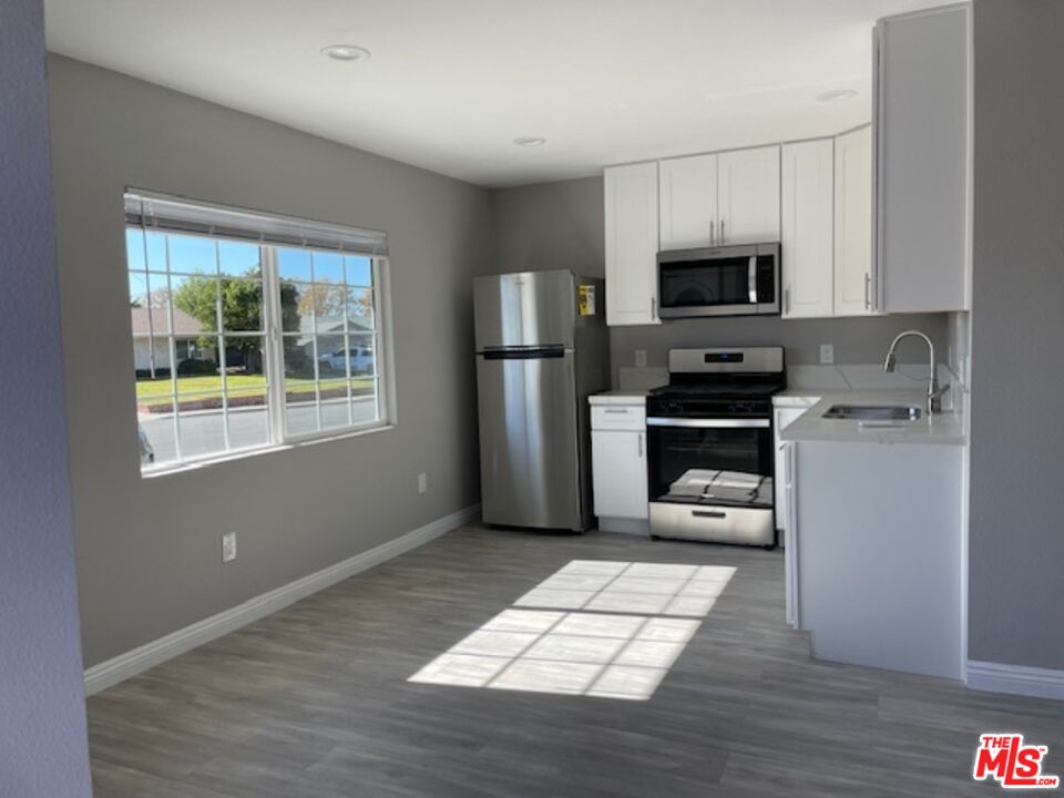 2615 Elizondo Avenue, Unit 2 Simi Valley, CA 93065 - Photo 12 of 20 a kitchen with stainless steel appliances a refrigerator stove microwave and sink