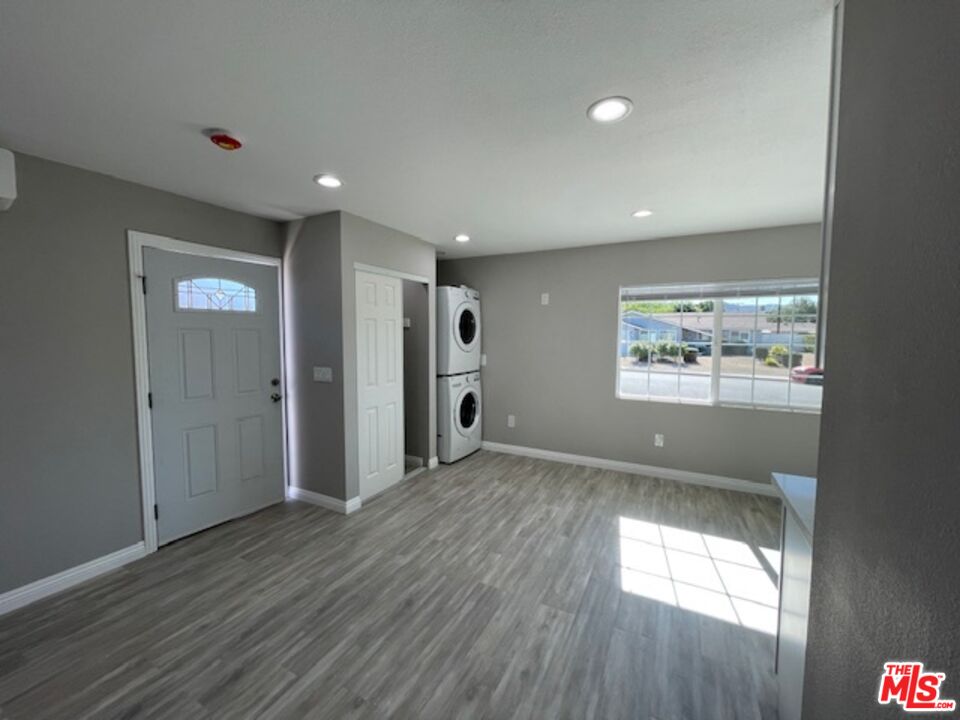 2615 Elizondo Avenue, Unit 2 Simi Valley, CA 93065 - Photo 13 of 20 an empty room with wooden floor and windows