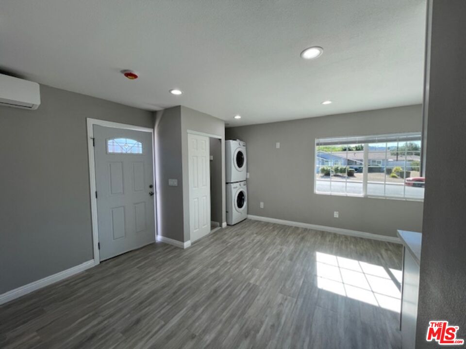 2615 Elizondo Avenue, Unit 2 Simi Valley, CA 93065 - Photo 6 of 20 an empty room with wooden floor and windows