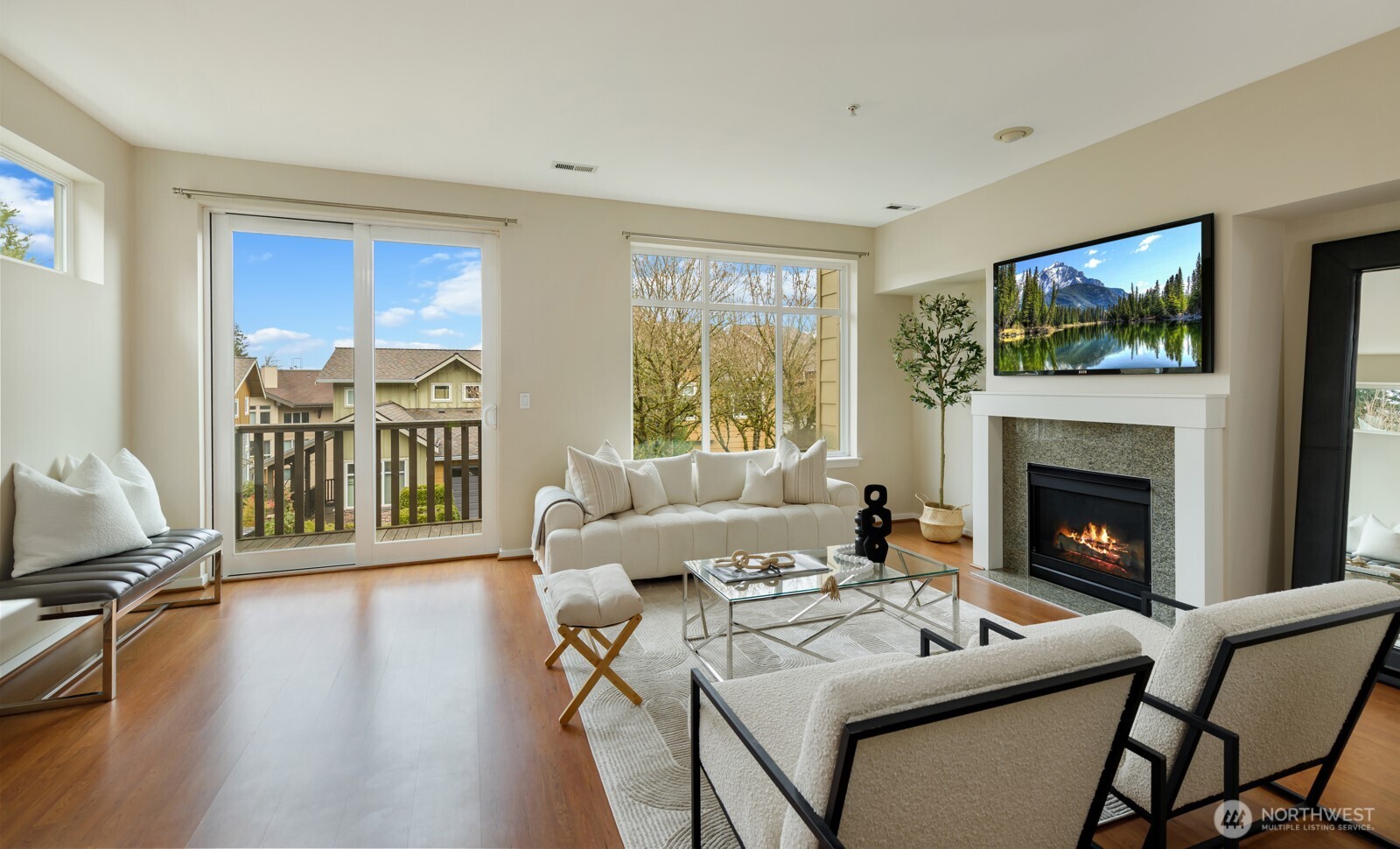 133 Cougar Ridge Road Northwest, Unit 1405 Issaquah, WA 98027 - Photo 3 of 30 a living room with furniture a fireplace and a flat screen tv