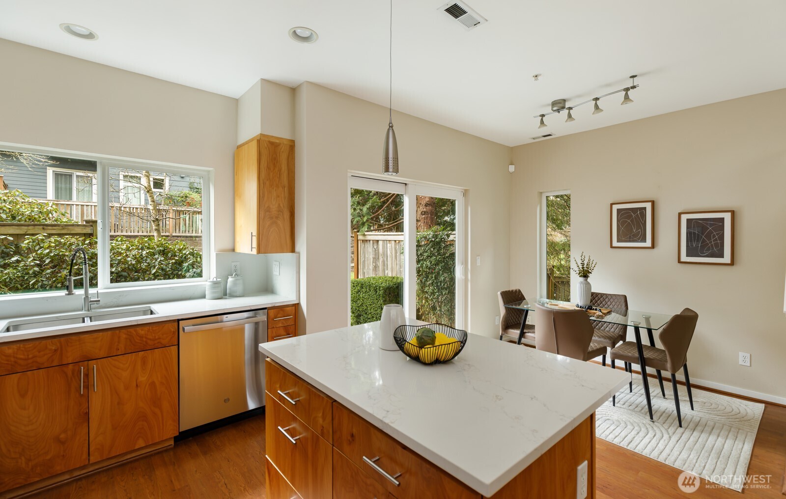 133 Cougar Ridge Road Northwest, Unit 1405 Issaquah, WA 98027 - Photo 7 of 30 a view of kitchen island with stainless steel appliances granite countertop a stove a sink a dining table and chairs