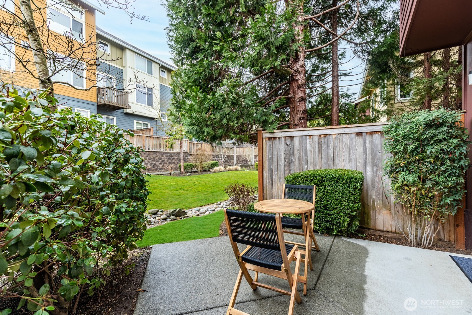 133 Cougar Ridge Road Northwest, Unit 1405 Issaquah, WA 98027 - Photo 10 of 30 a view of a chair and table in backyard of the house